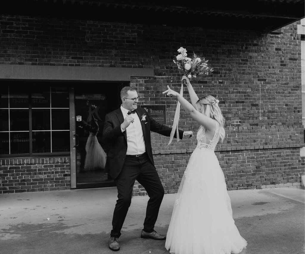 Fun bride and groom dancing with joy, captured by Ninth Avenue Studios, elegant and romantic wedding photographer in Saskatoon, Calgary and Vancouver. Featured on the Bronte Bride Vendor Guide.