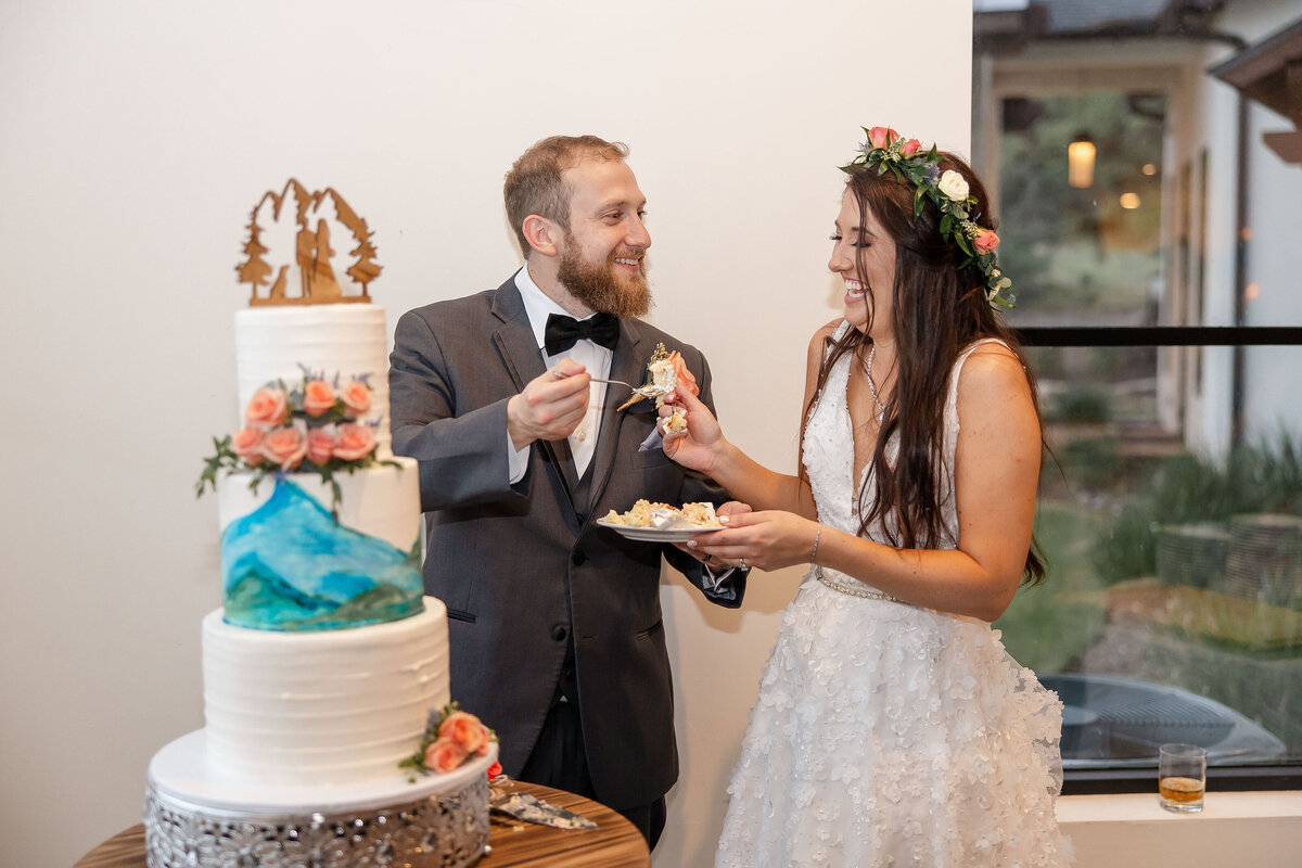 bride and groom cutting of the cake with painted icing at Texas hill country wedding