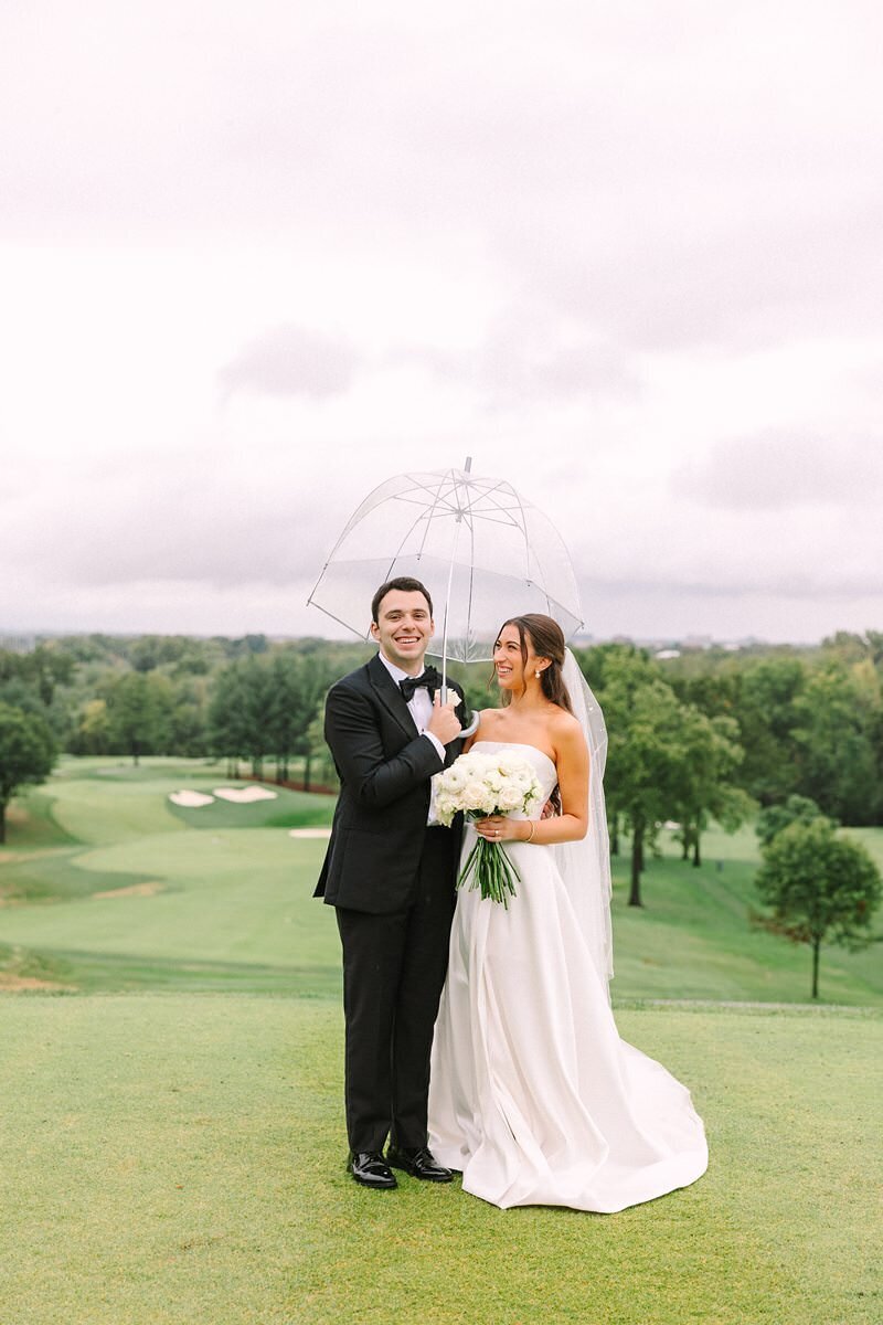 bride-and-groom-rainy-umbrella-evansville-country-club08