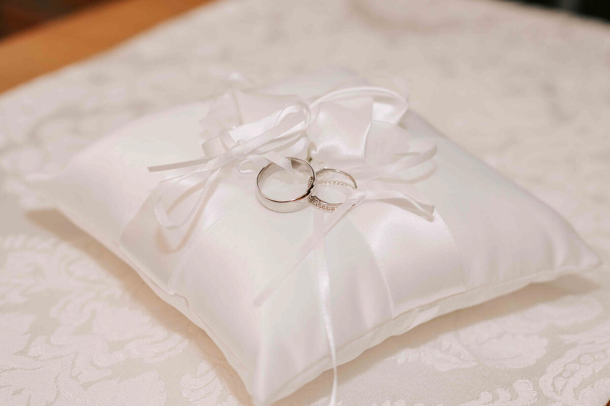 Wedding rings tied on a pillow.