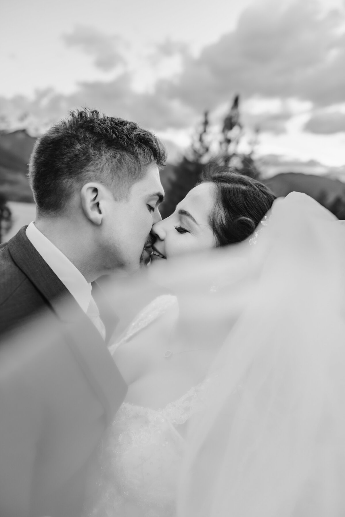 black and white wedding photos of couple kissing