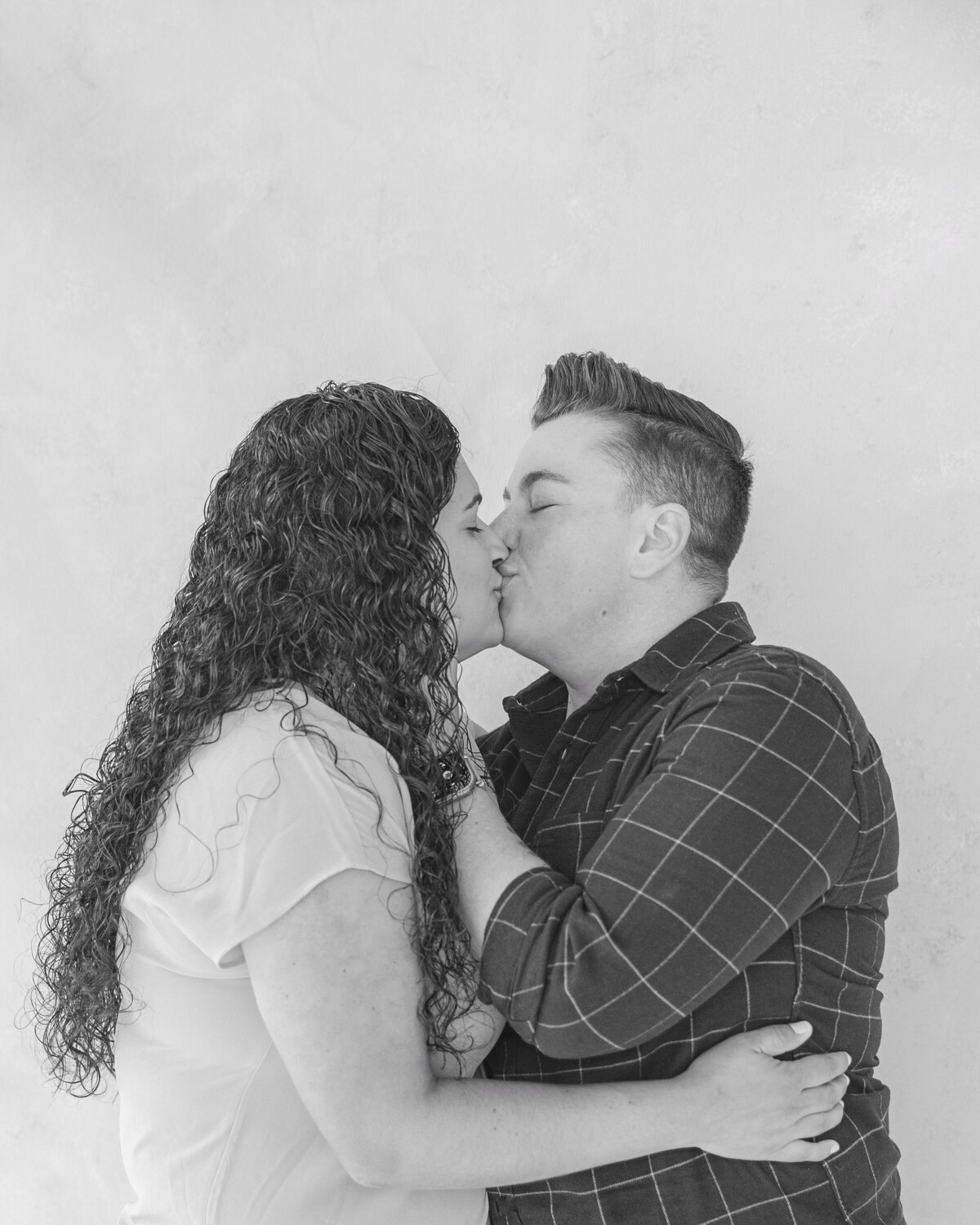 Couple kisses in Emeryville portrait studio