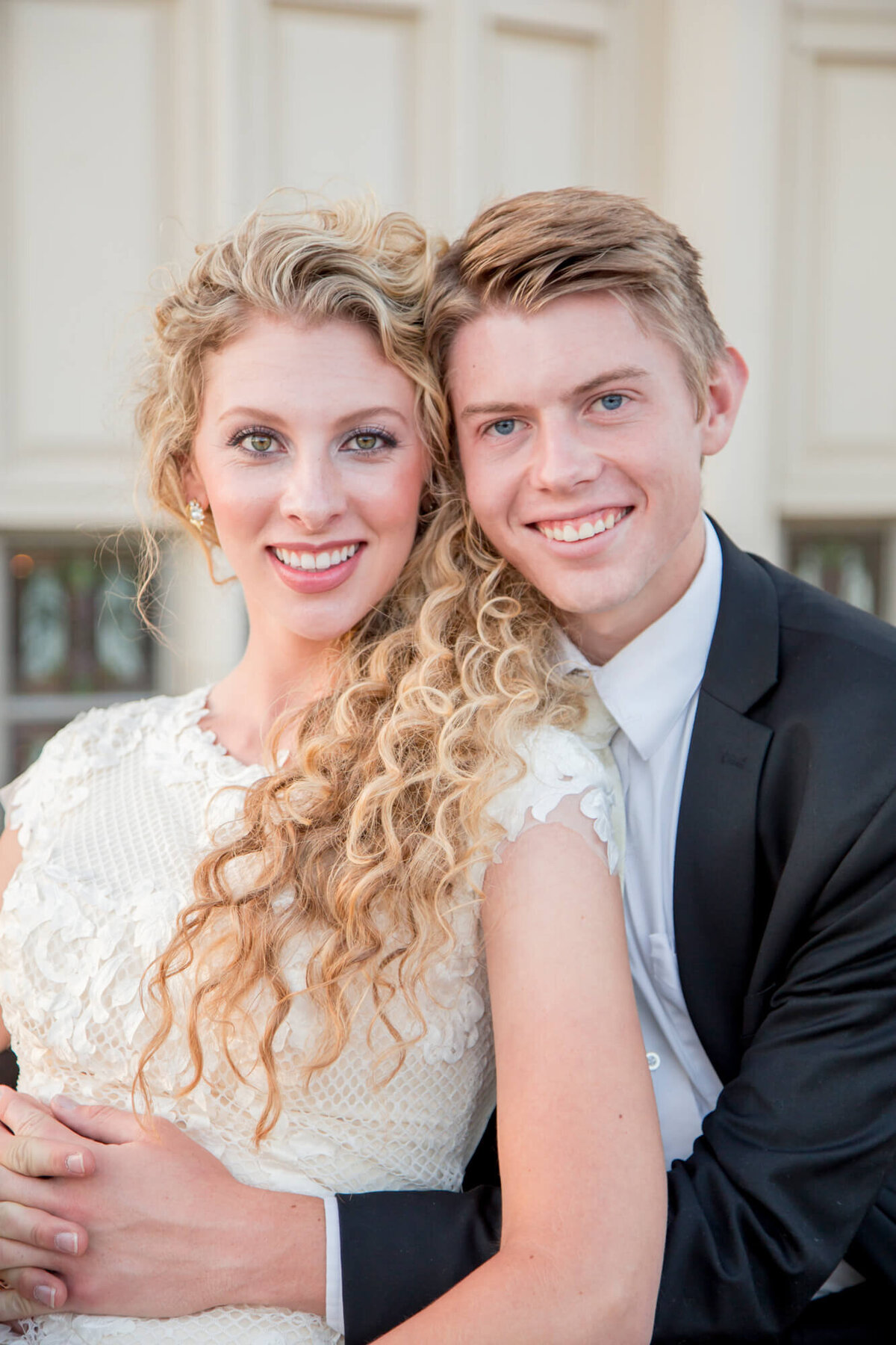 a wedding couple smiling