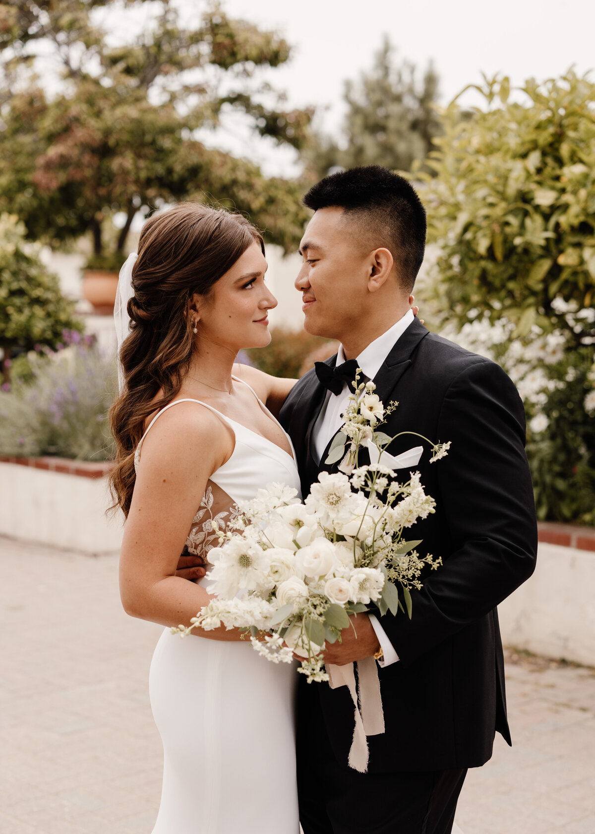 bride and groom holding bouquet on wedding day