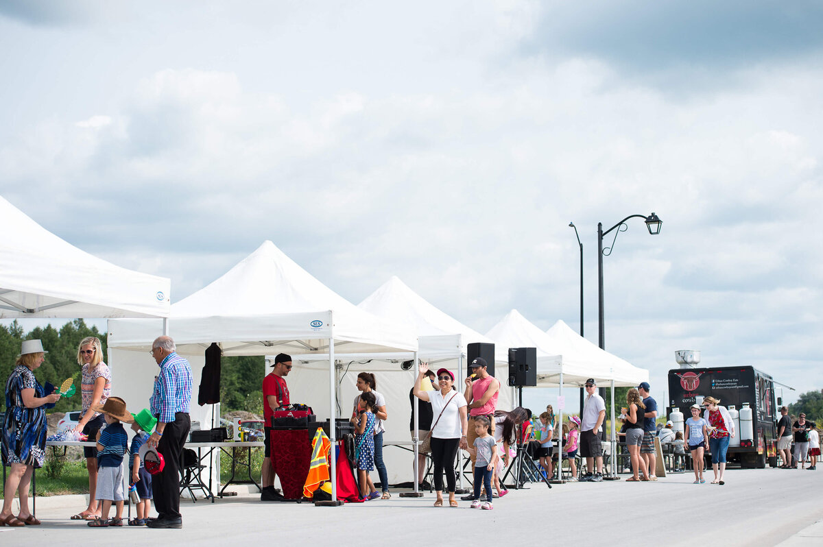 Ottawa event photography showing a wide angle view of participants walking and engaging with vendors during a corporate children's event.  Captured by JEMMAN Photography COMMERCIAL