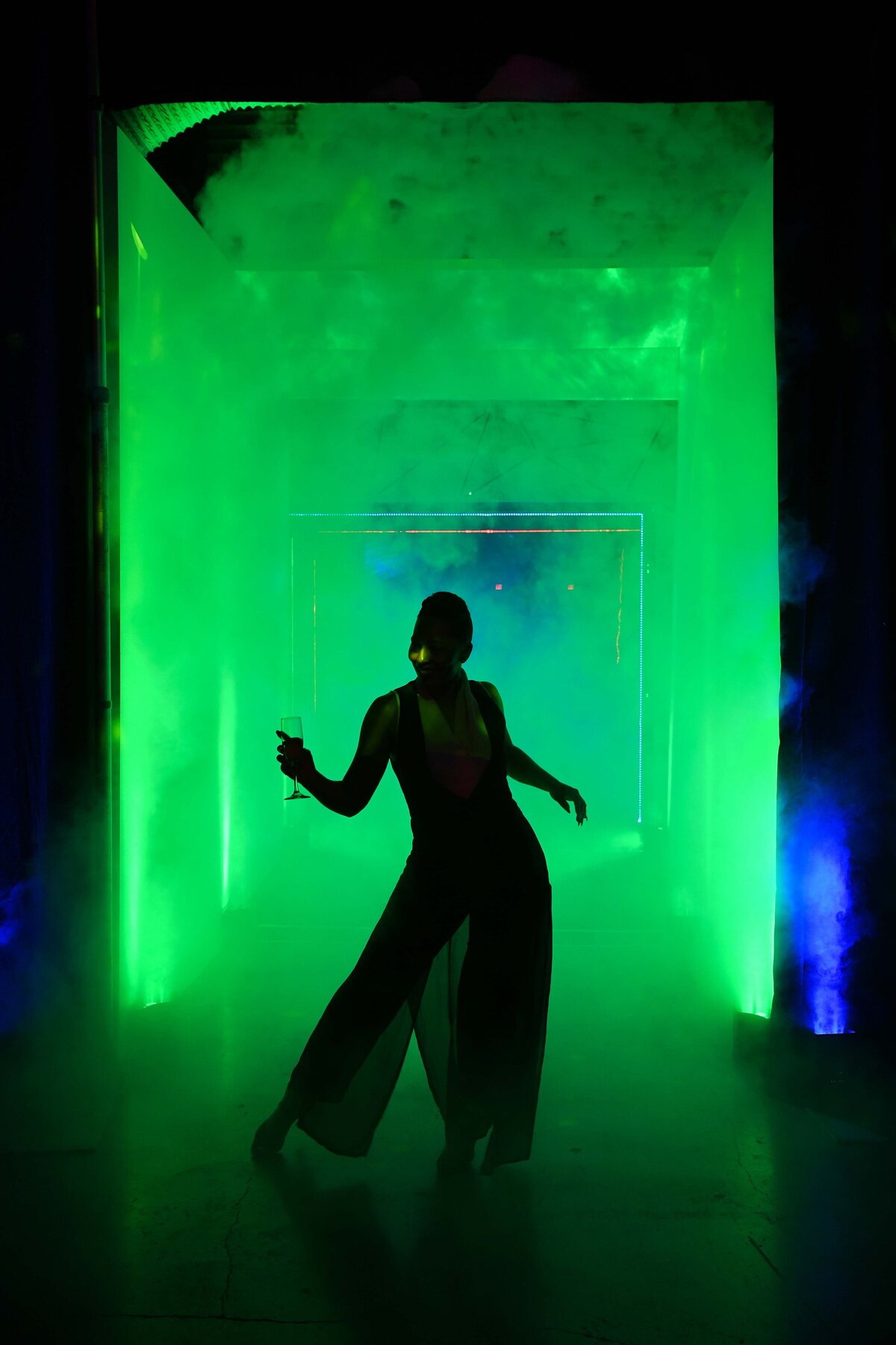Actor with green fog lit around her for intriguing creative image that highlights her gesture.