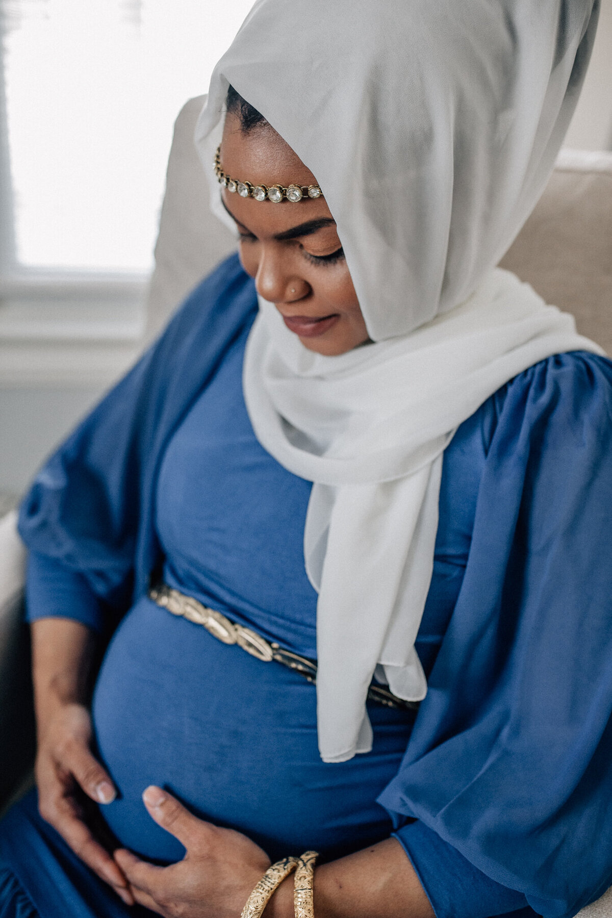 Maternity shot of a soon to be mom holding her belly.