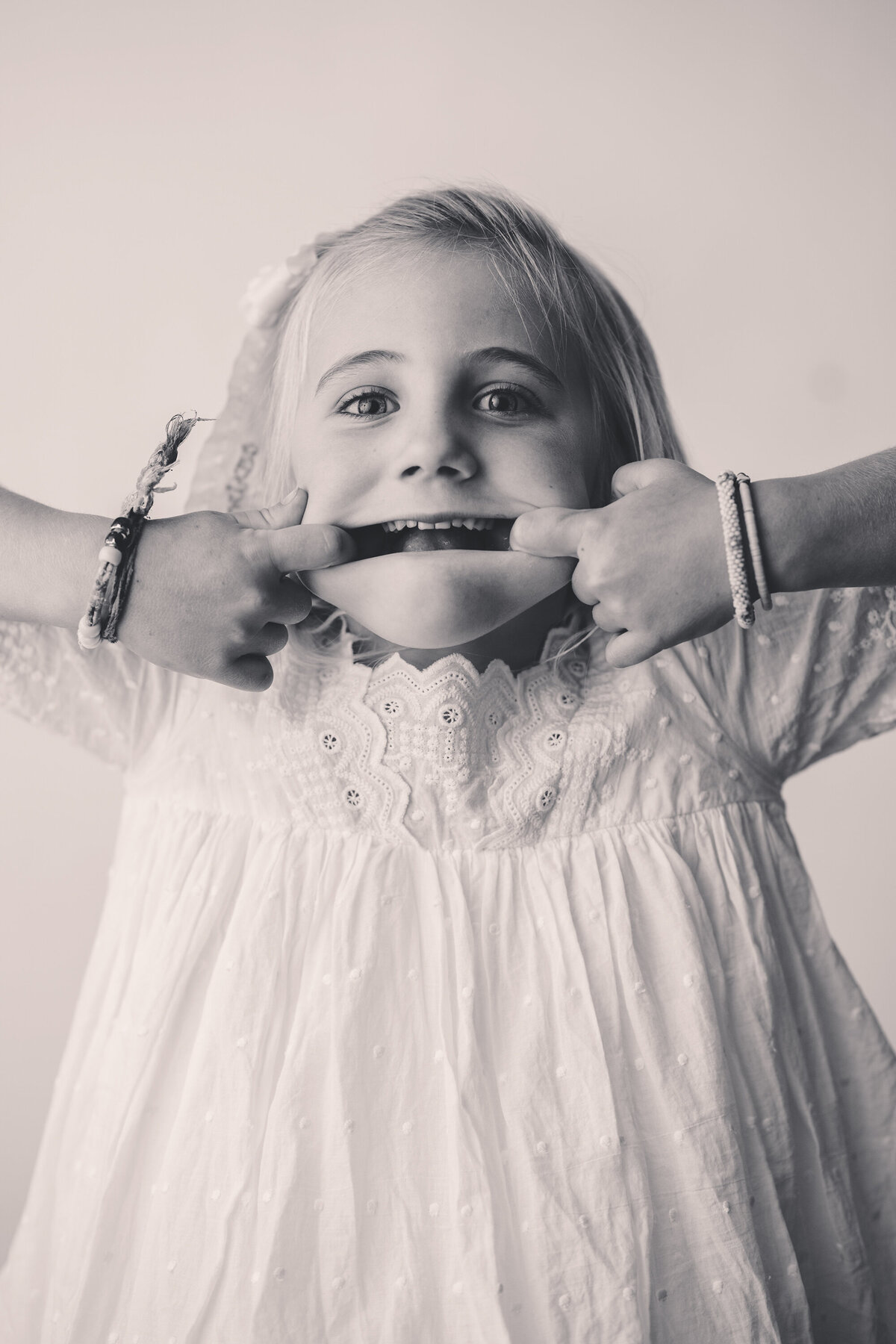 Little girl makes a silly face at the camera during Personality Portrait Session in Charleston, SC.