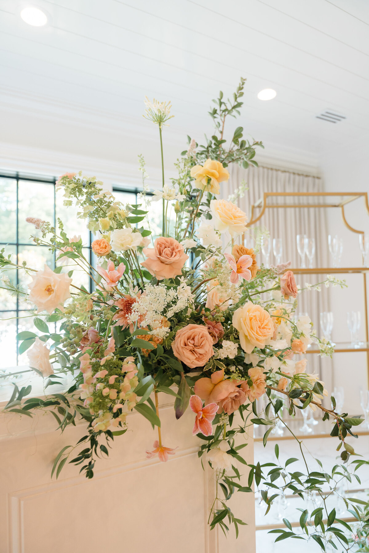 Floral arrangement with orange and white flowers, indoor setting.