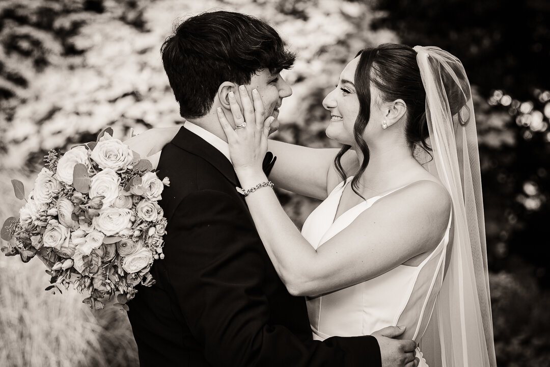 Bride and groom sharing a joyful embrace on their wedding day, captured in a black and white portrait by Alex Kaplan Wedding Photography in New York City and Northern New Jersey.