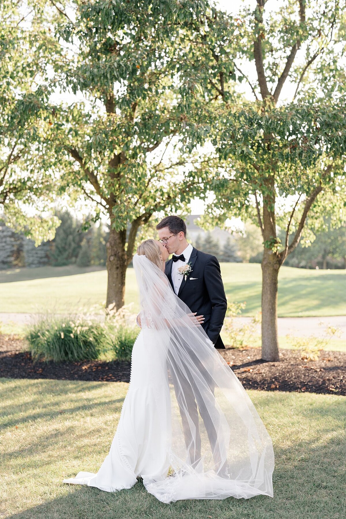 Columbus wedding  photographer photographs bride and groom kissing at sunset on the golf course the the Pinnacle