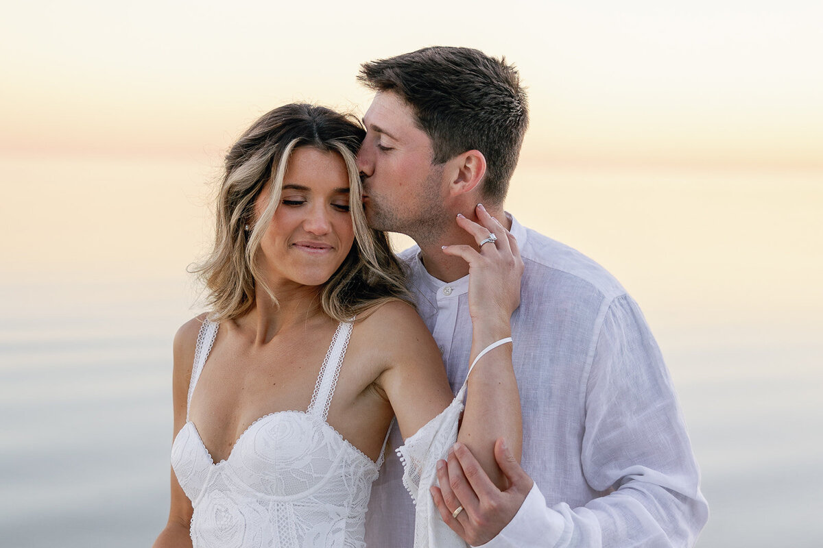 Newlyweds Laura and Abraham embracing on the dock at sunset after their Miami destination wedding.