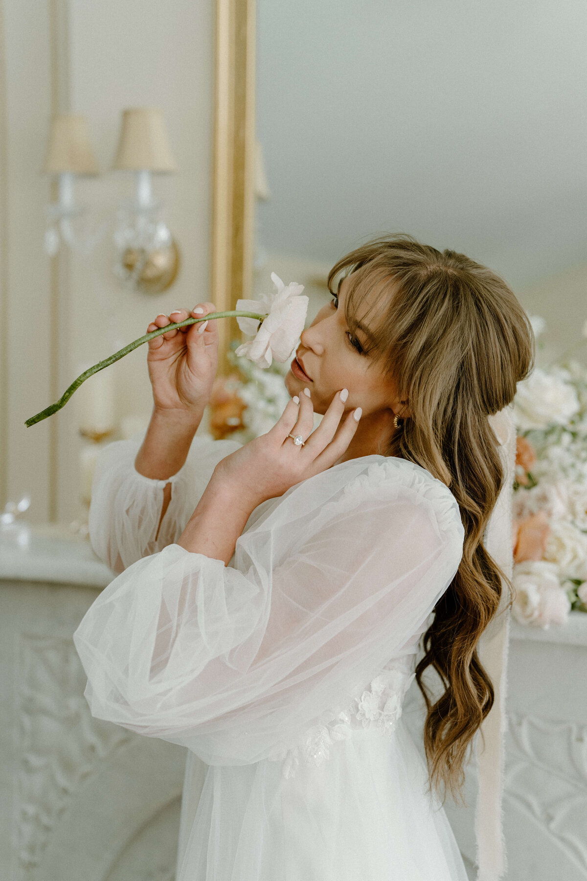 bride smelling white flower