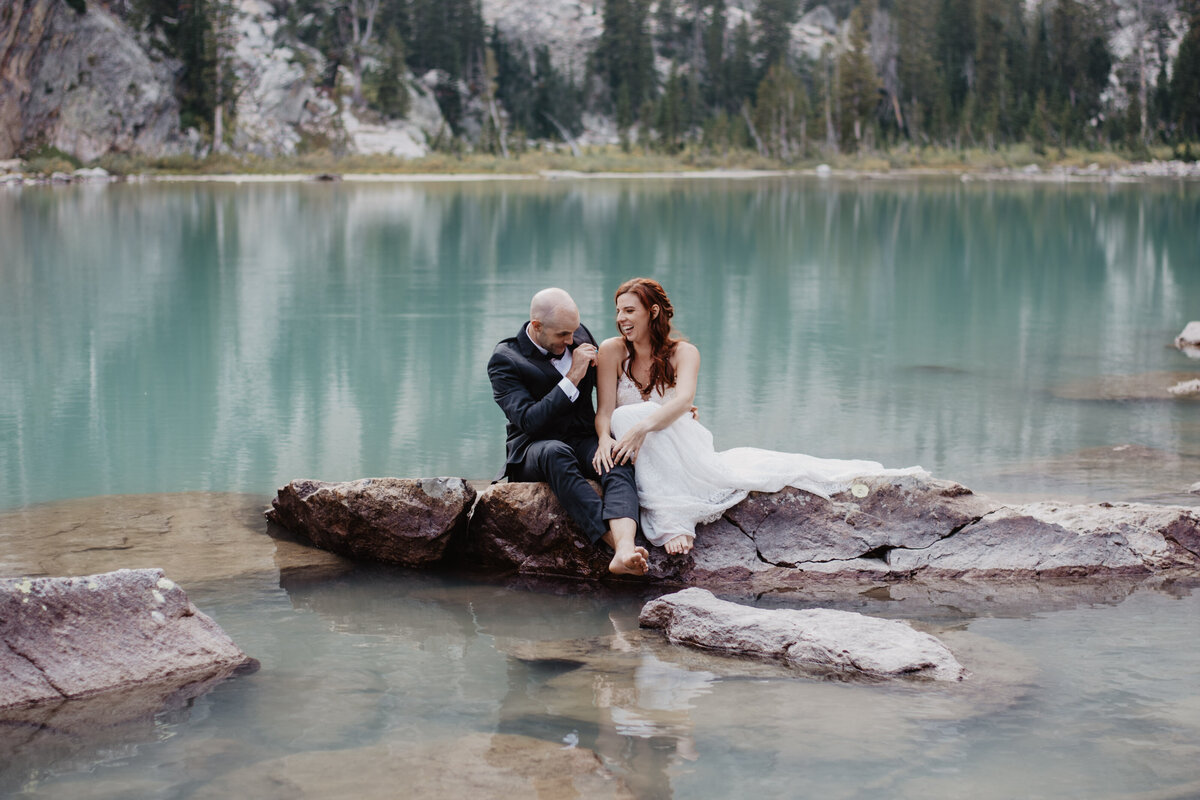 Jackson Hole Photographers capture groom laughing during outdoor bridal portraits