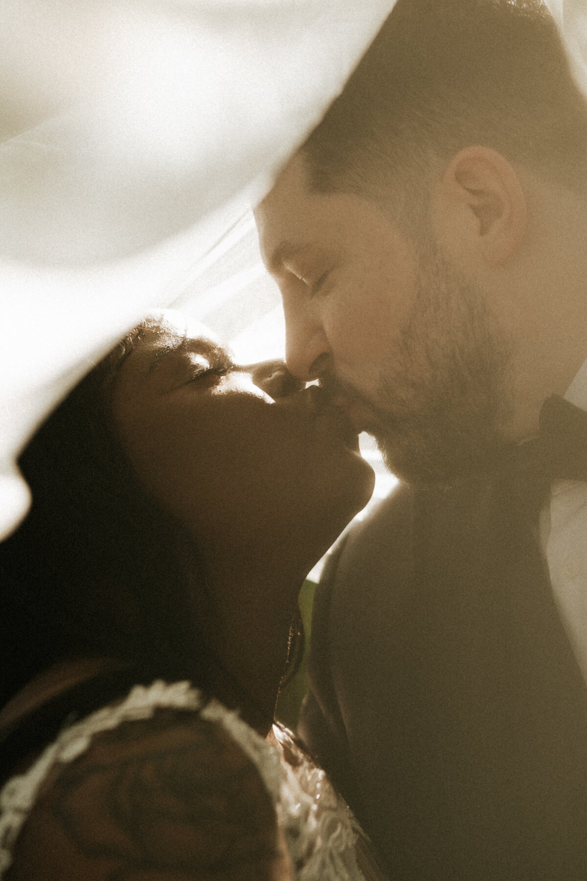 happy newly married couple sharing kiss