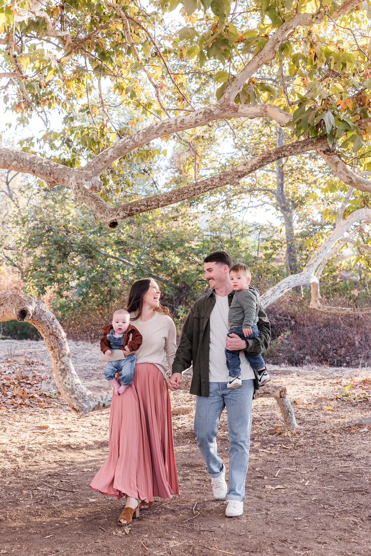 parents-young-children-walking-treejpg