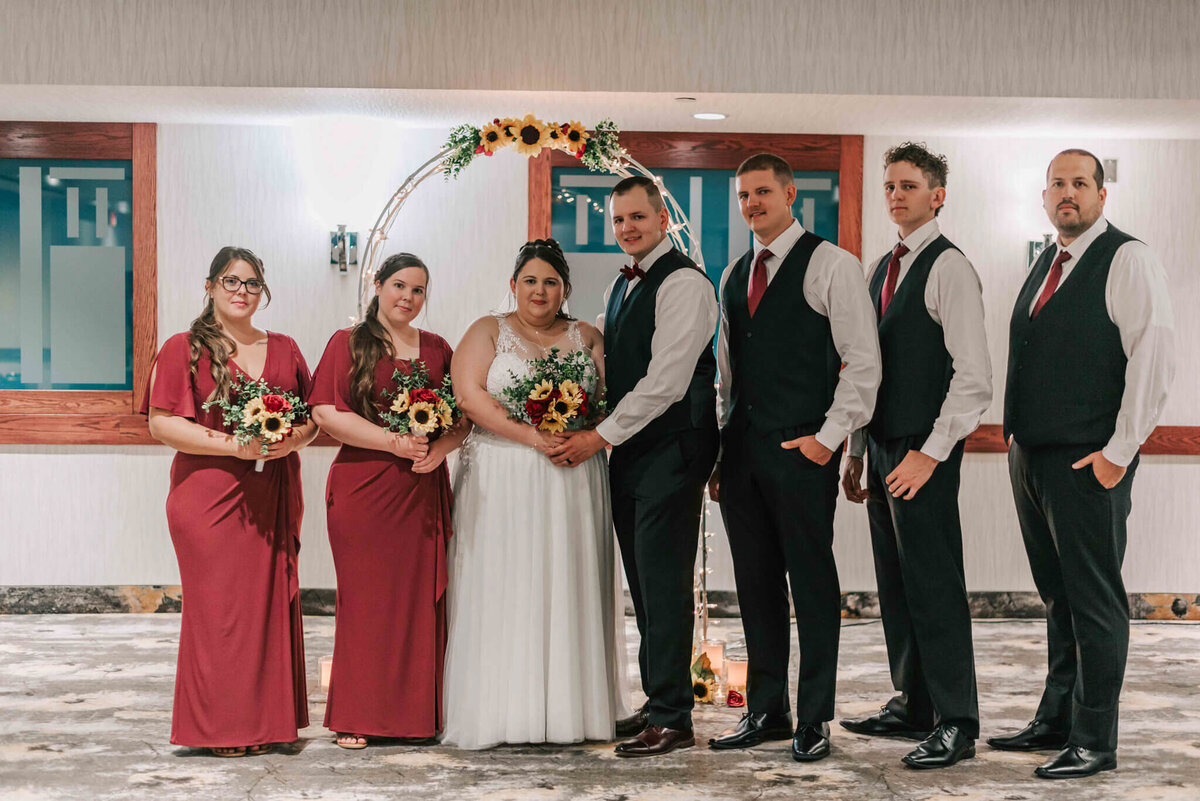 Bride and groom standing with bridal party.