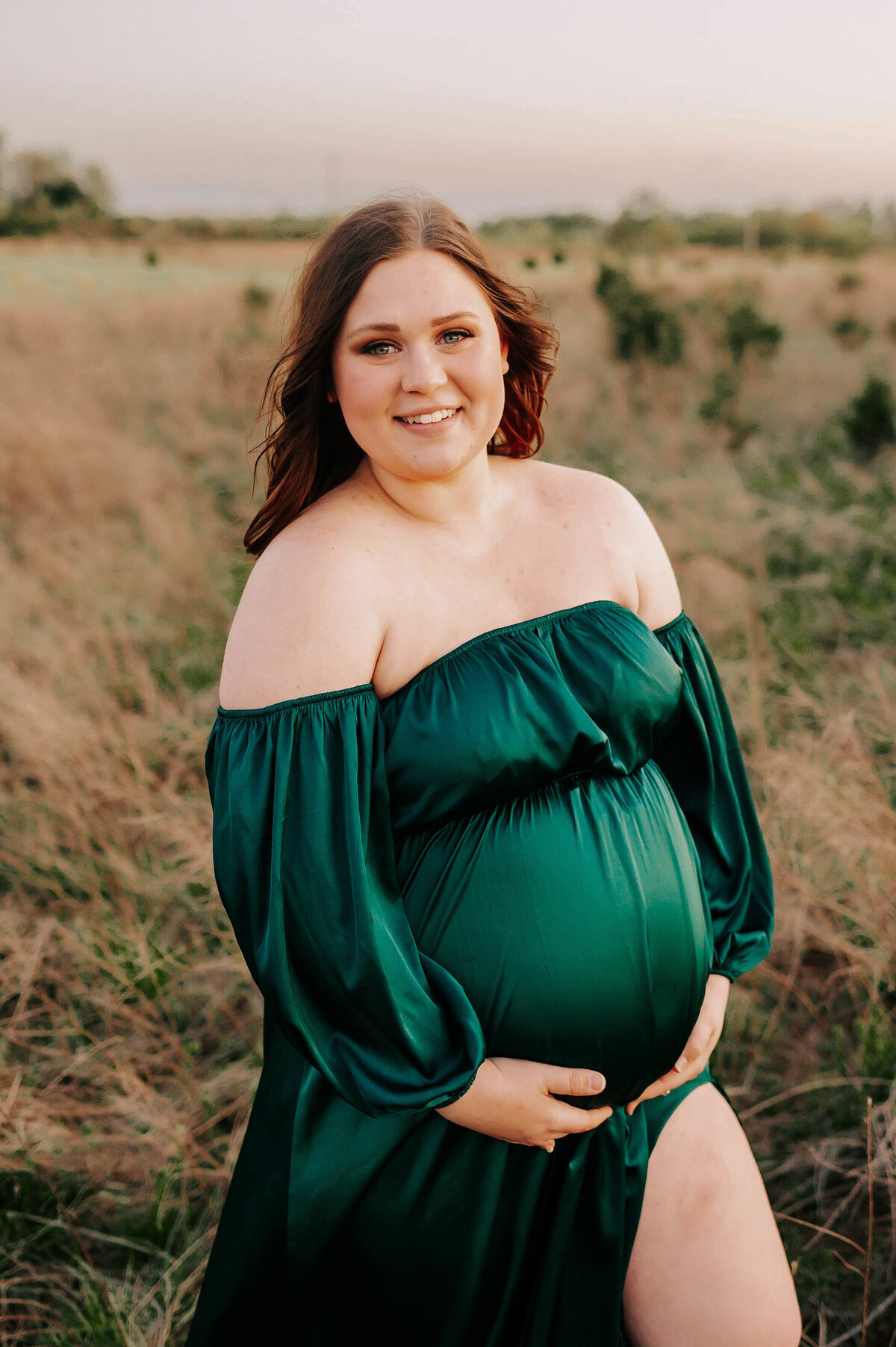 pregnant mom smiling and enjoying maternity photographer in Joplin MO