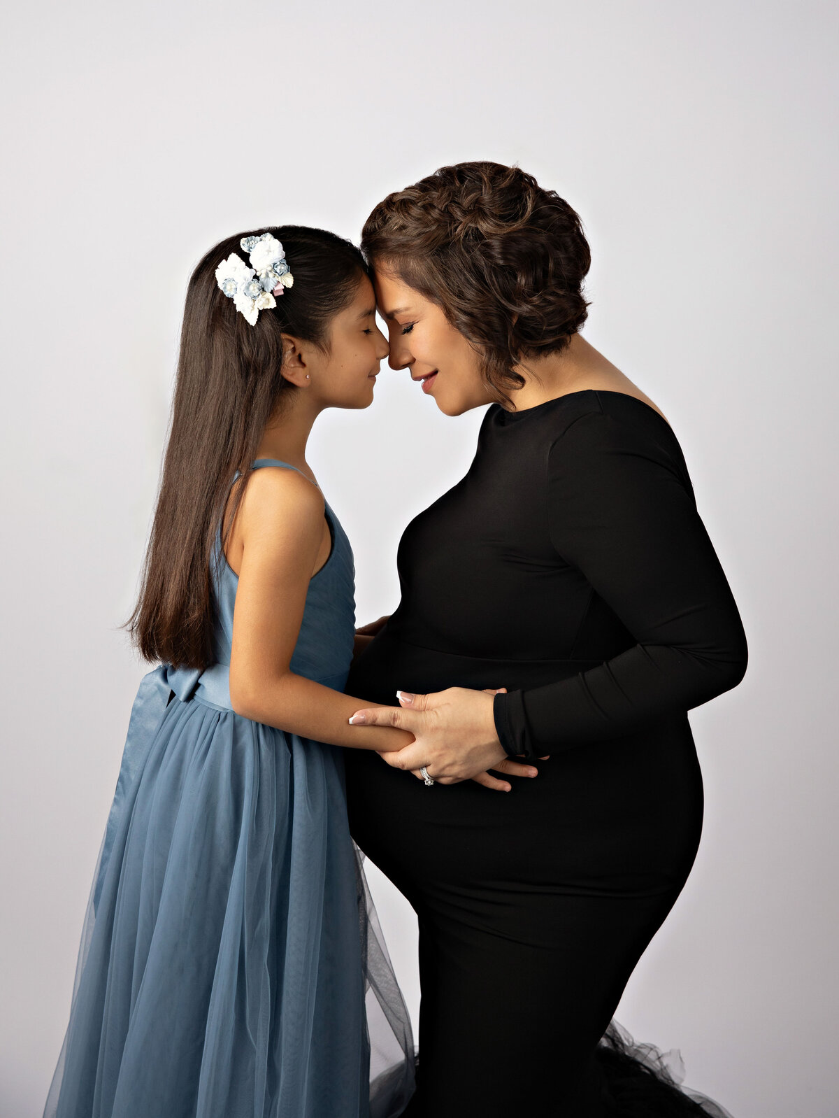 gorgeous image of expectant mom with daughter during maternity photoshoot 