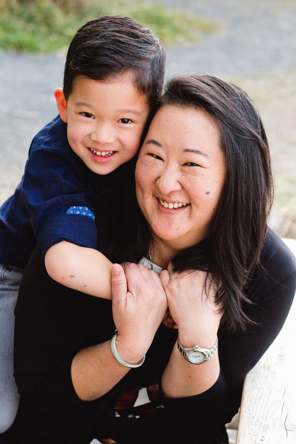 a young son hugs his mom