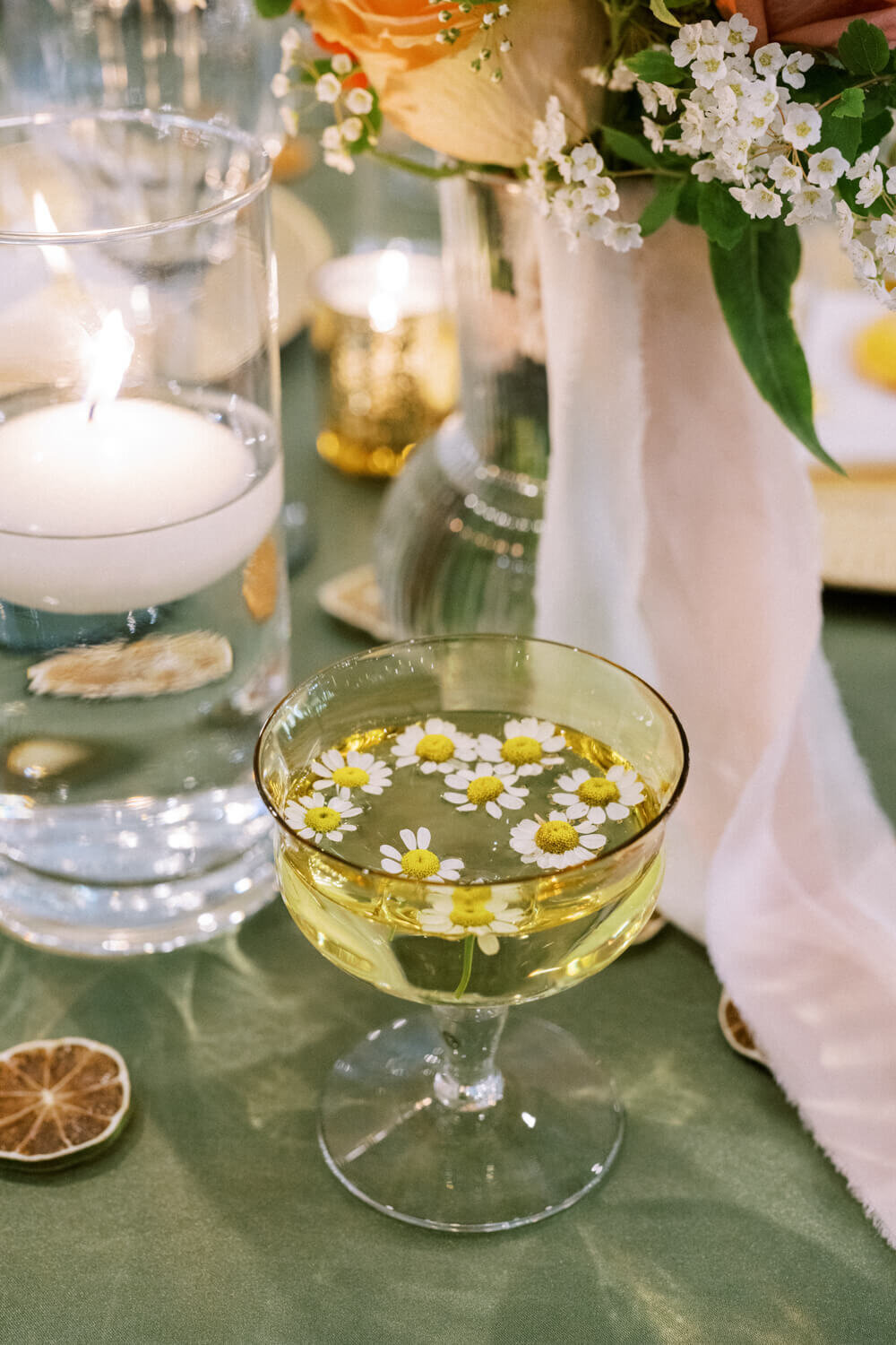 daisies-floating-in-water-in-colorful-goblets