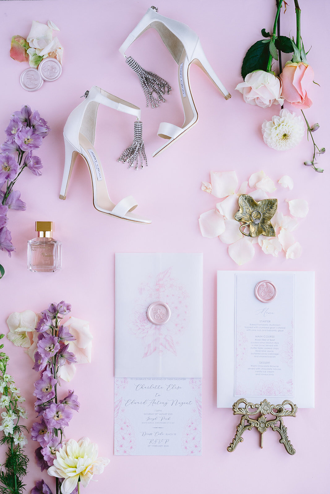 wedding flat lay of the brides details and invite