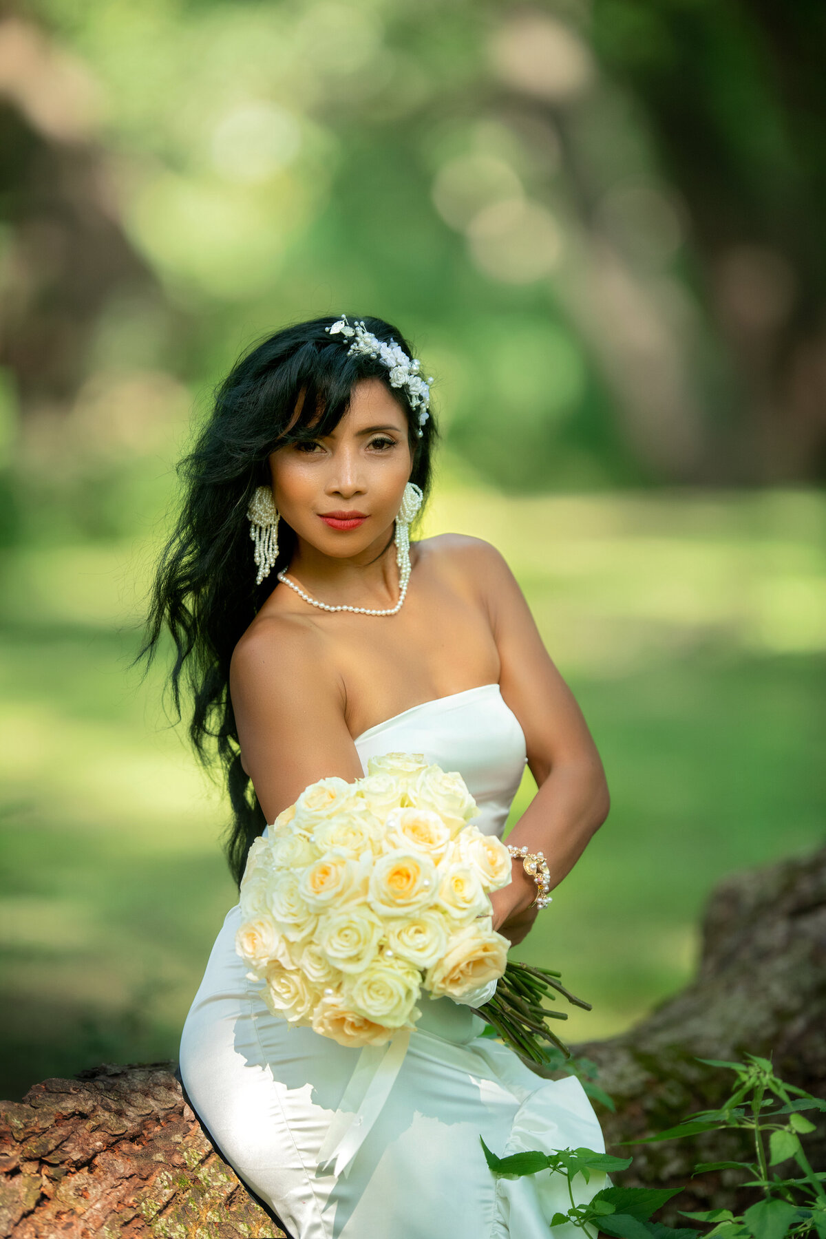 Portrait of bride in white dress with bouquet of white roses