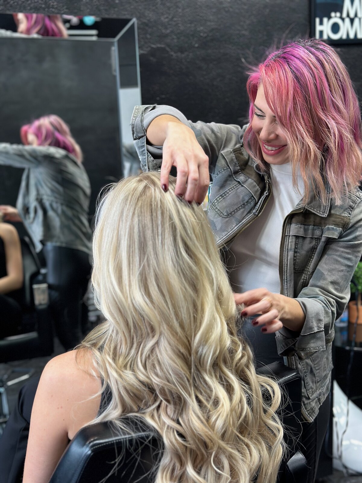 hairstylist styling woman's blonde hair