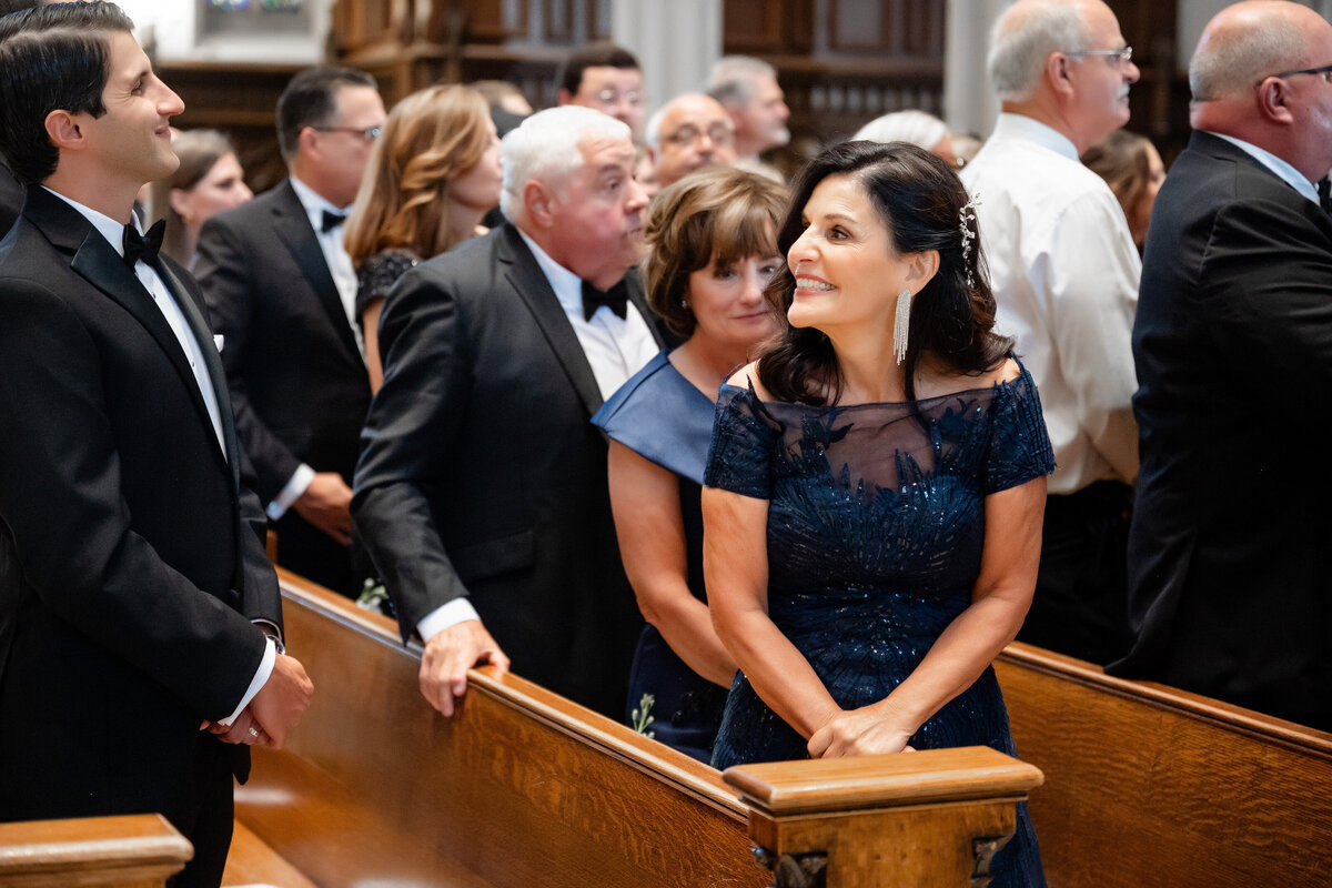 mother of groom beaming with pride during wedding ceremony