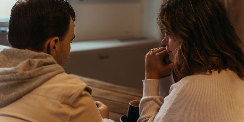 Candid photo of couple gazing at each other in Central Maine Coffee Shop