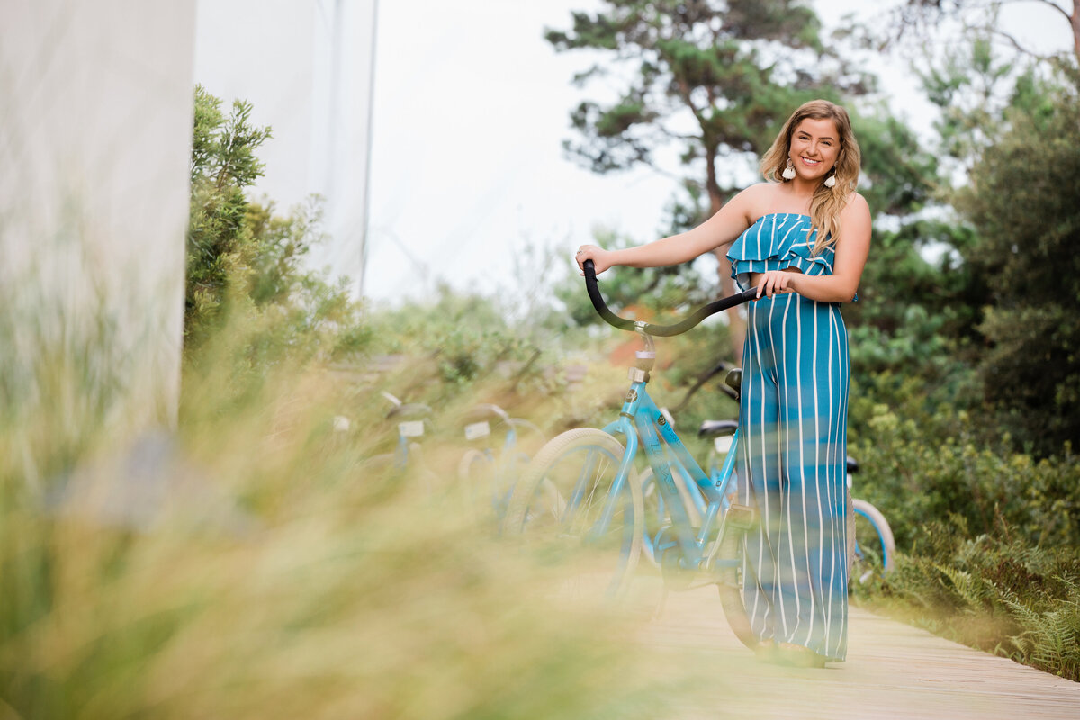 A girl standing with a bike