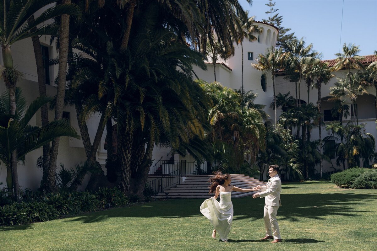 Bride and Groom running through Santa Barbara Courthouse 