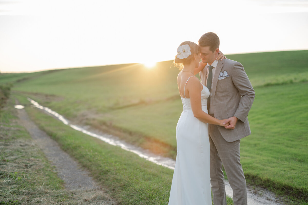 Scène bucolique en fin de journée alors que le mariage champêtre se termine sous un soleil orangé à l’Auberge West Brome, en Montérégie, moment paisible et lumineux capturé au cœur de la campagne québécoise