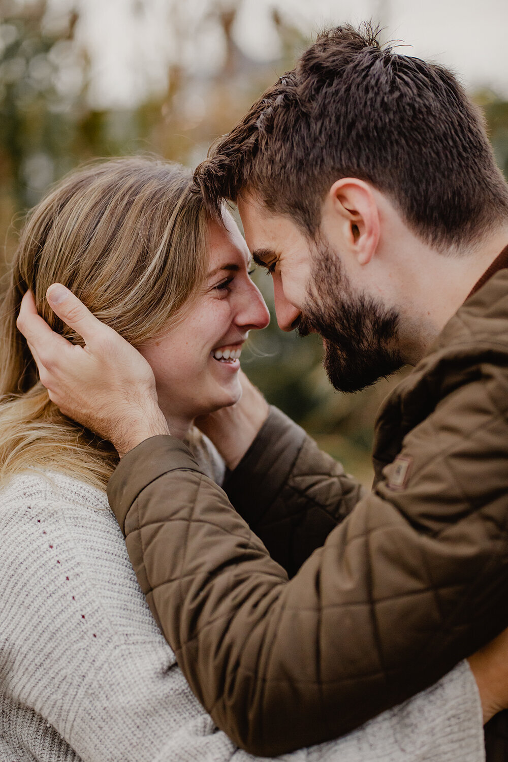 A newly engaged couple look at each other lovingly during a fall engagement session in New Jersey.