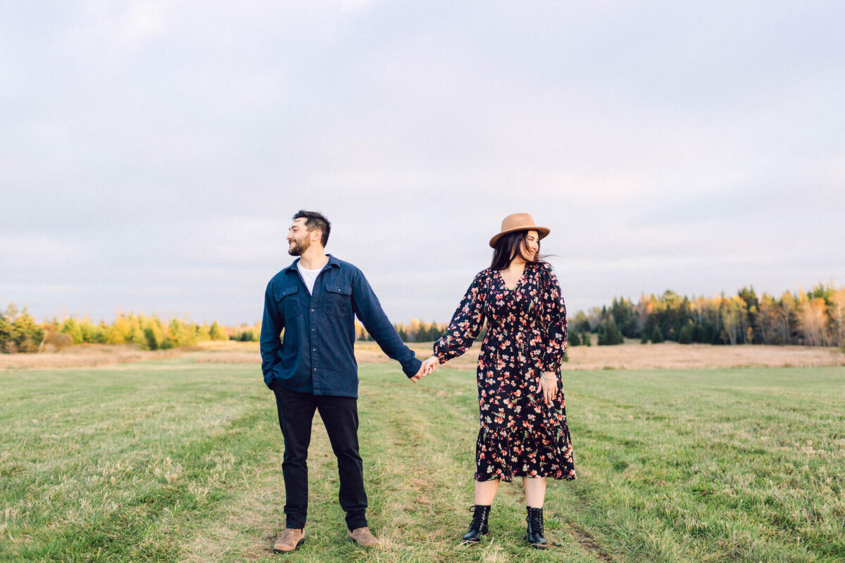 couple-holding-hands-looking-opposite-ways