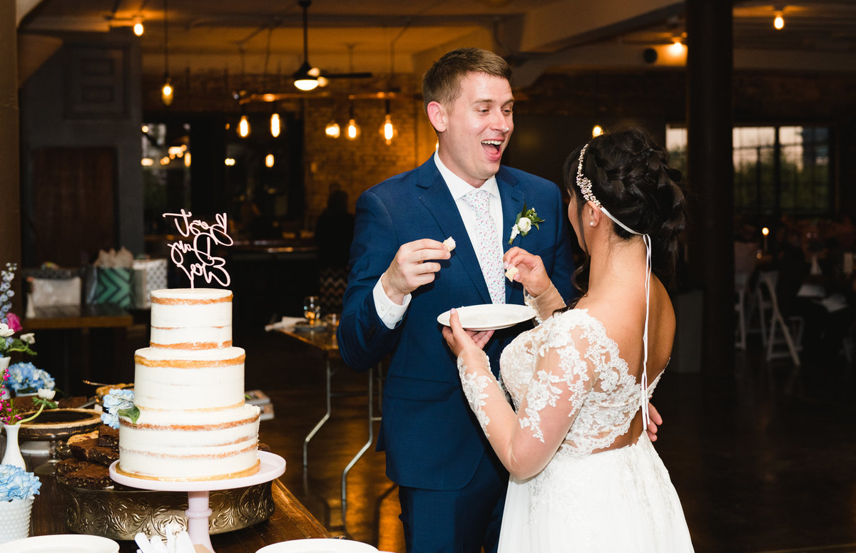 bride and groom eating cake in Chicago