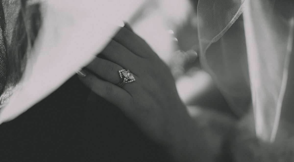 Bride's hand on groom's shoulder