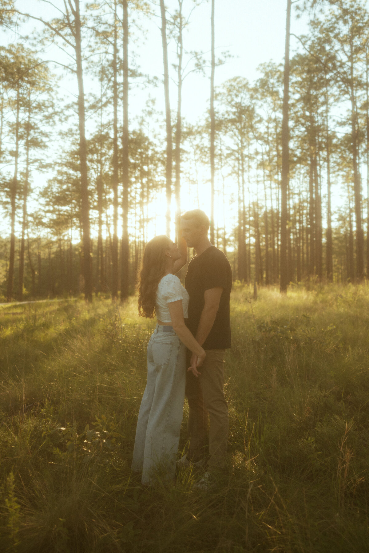 Couple posing for portraits in a forest.