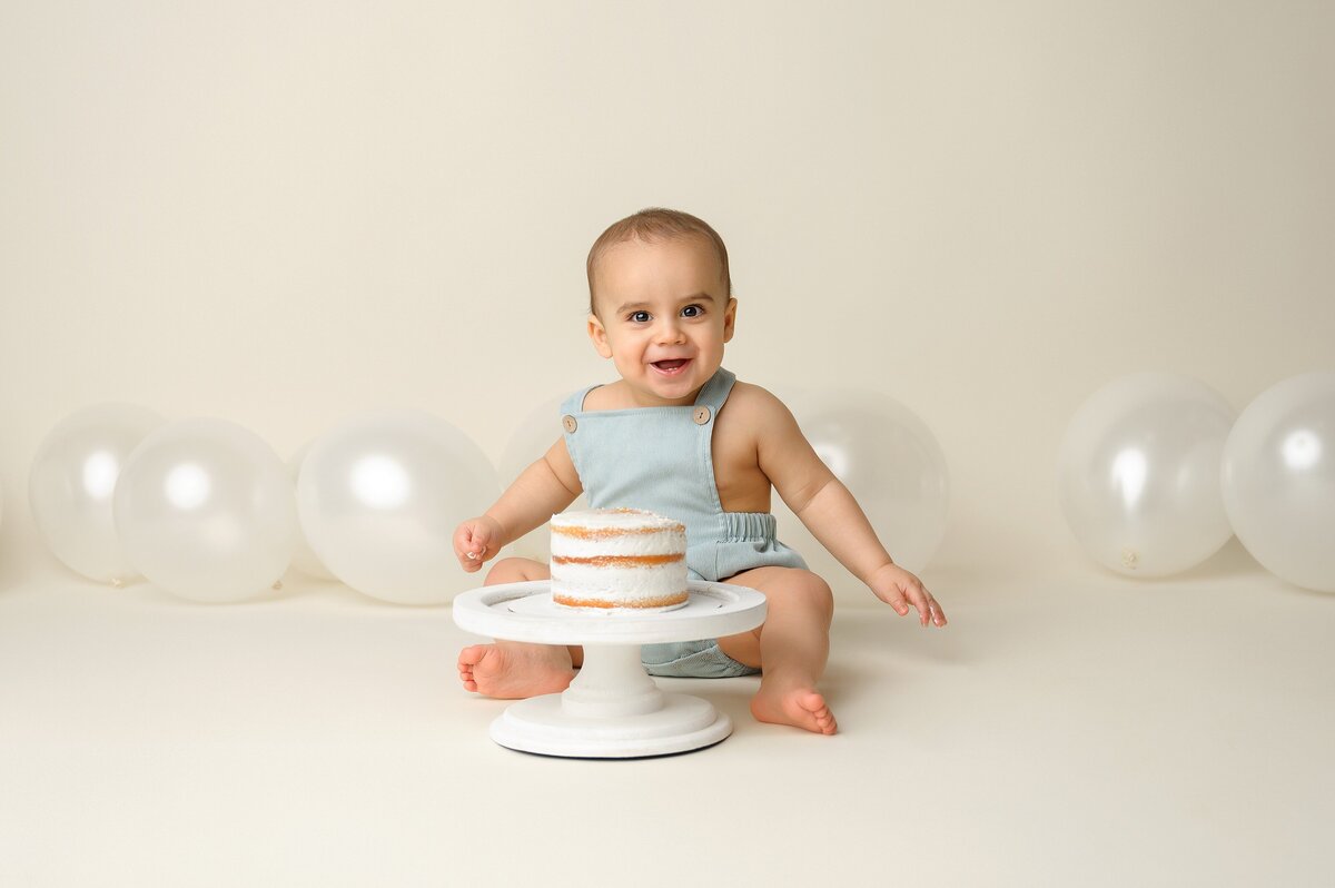 First birthday photoshoot in timeless neutral theme with pop of blue.