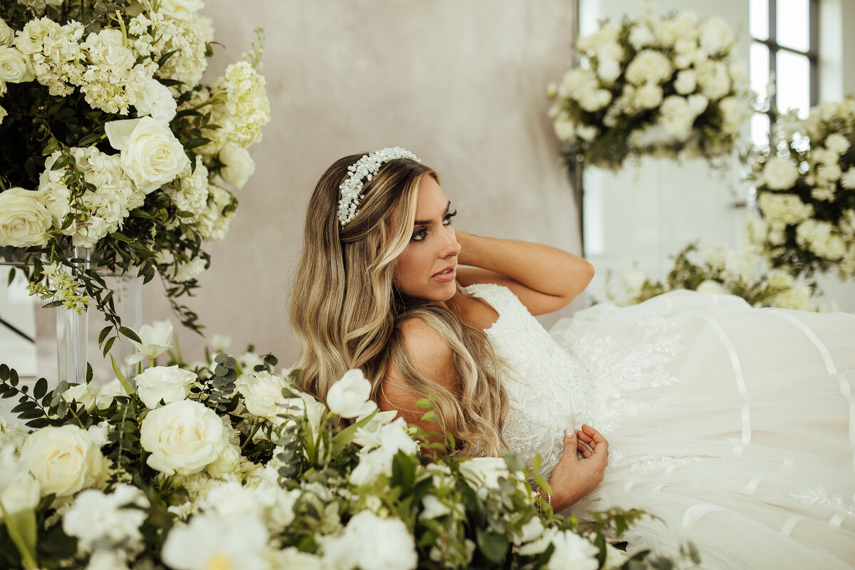 Beautiful bride lays in flowers
