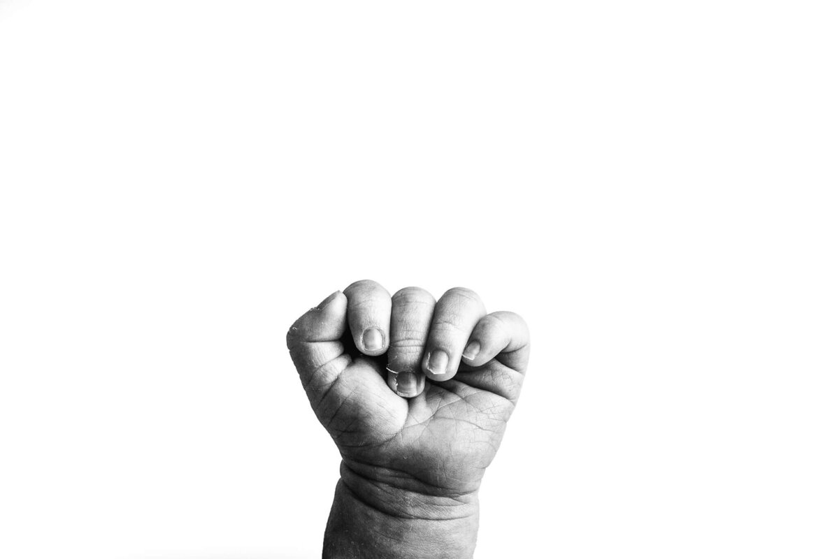 black and white detail shot of newborn's tiny fingers captured by Atlanta baby photographer