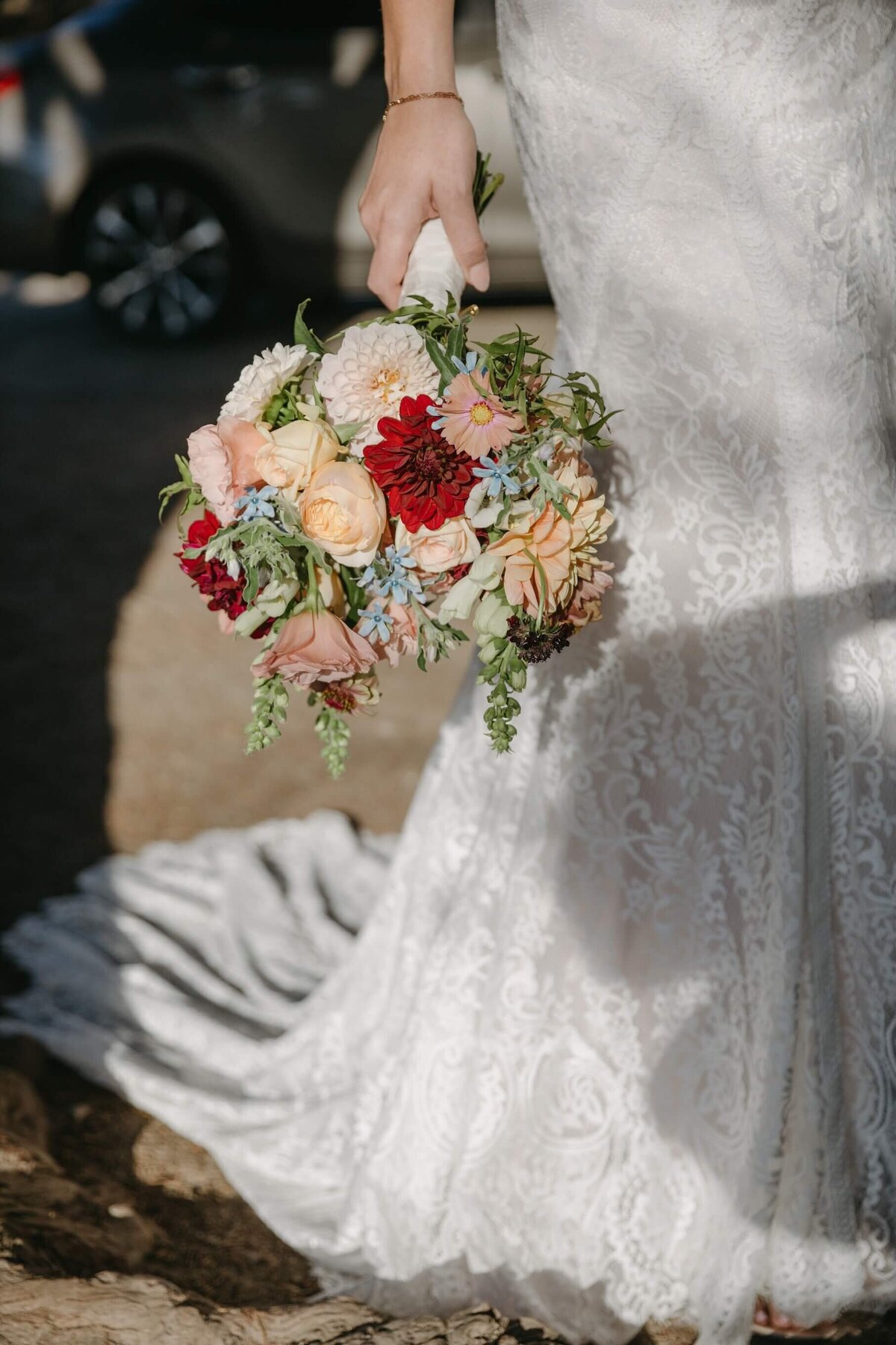 Colorful Fall bridal bouquet at a wedding ceremony on Monastery Beach in Carmel-by-the-Sea