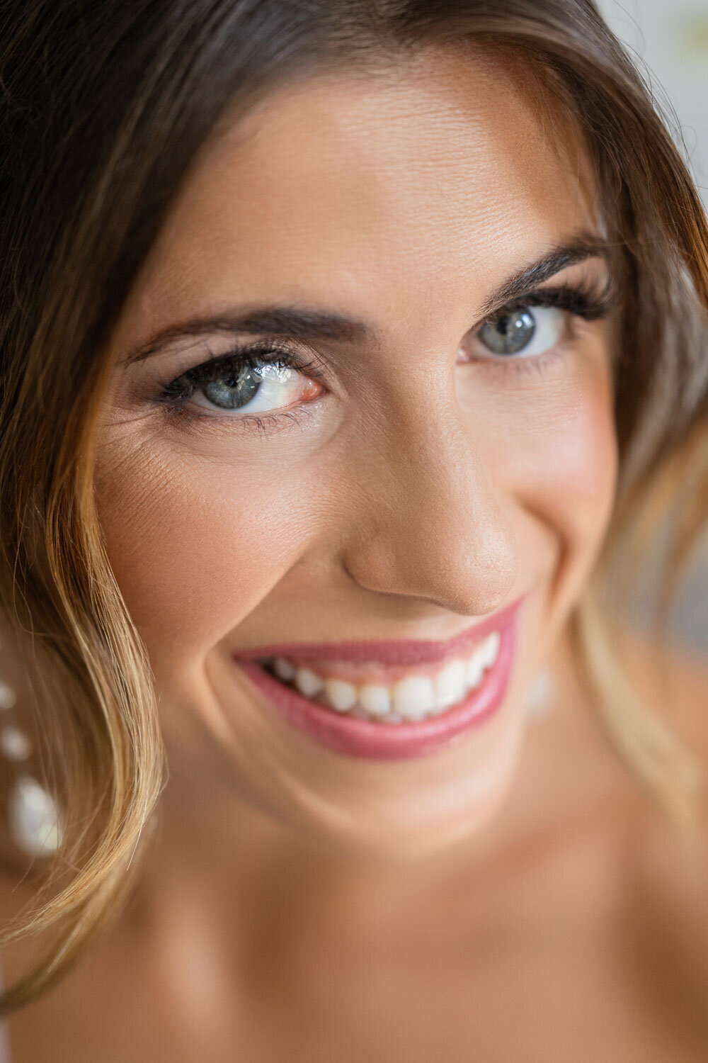 A close up of a woman 's face with a smile on her face