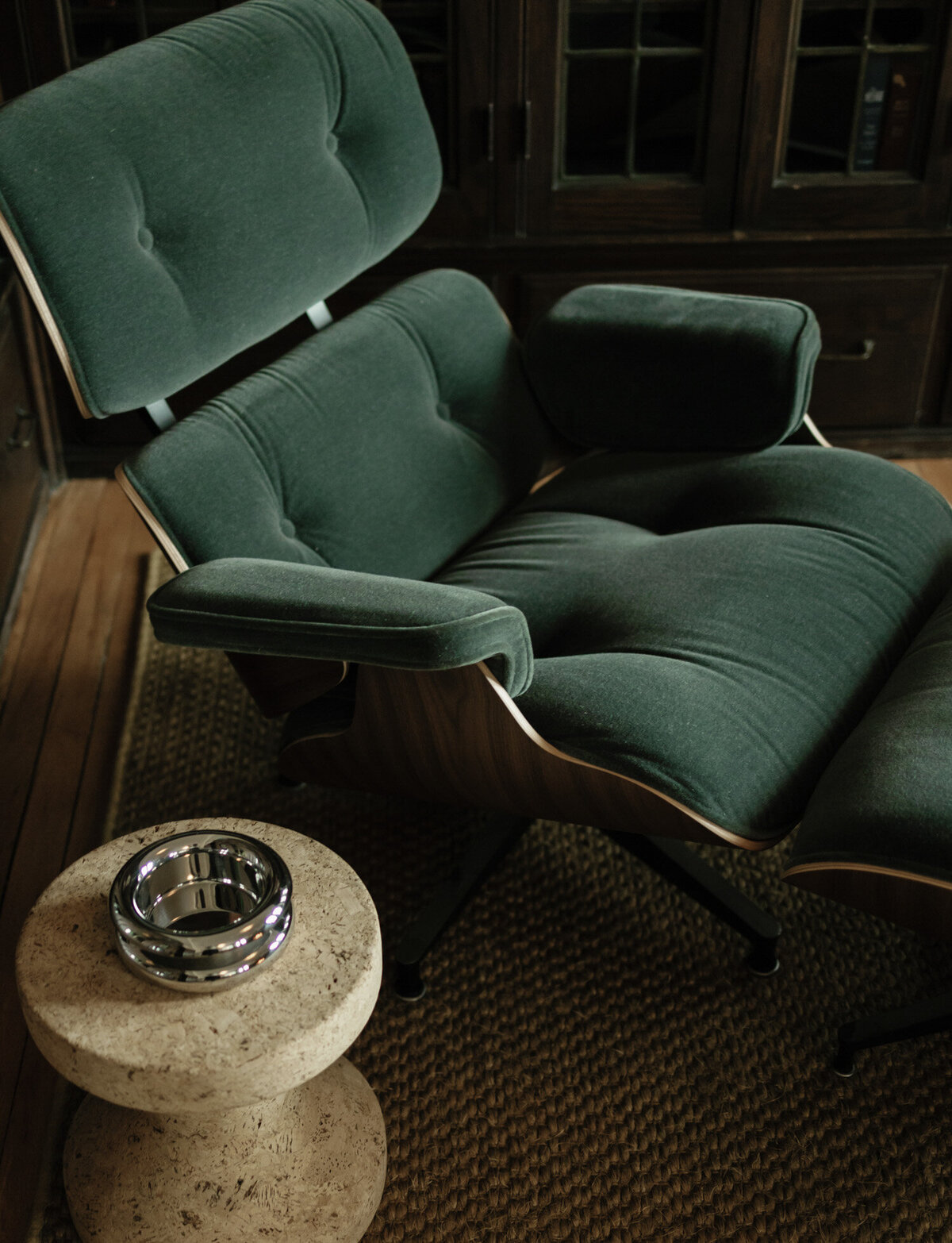 dark green upholstered reclining chair, side table, interior detail film photography in Detroit