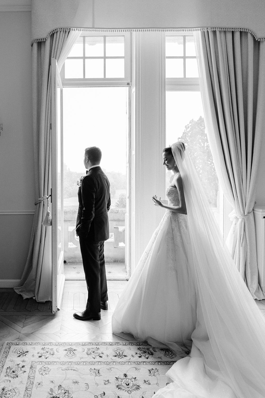 Side view of the bride and groom in black and white
