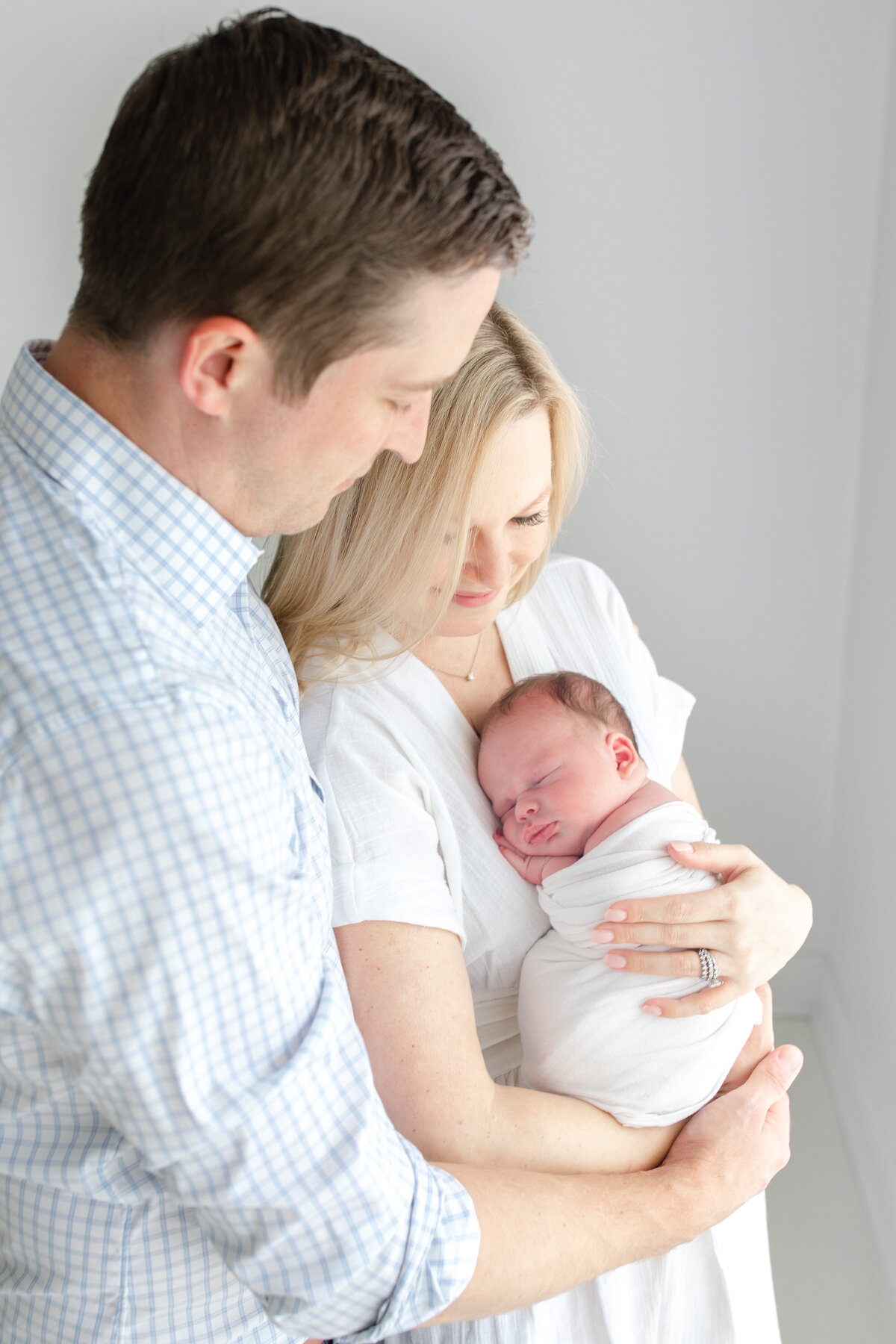 Buckhead Newborn Photographer- parents holding baby lifestyle newborn photos