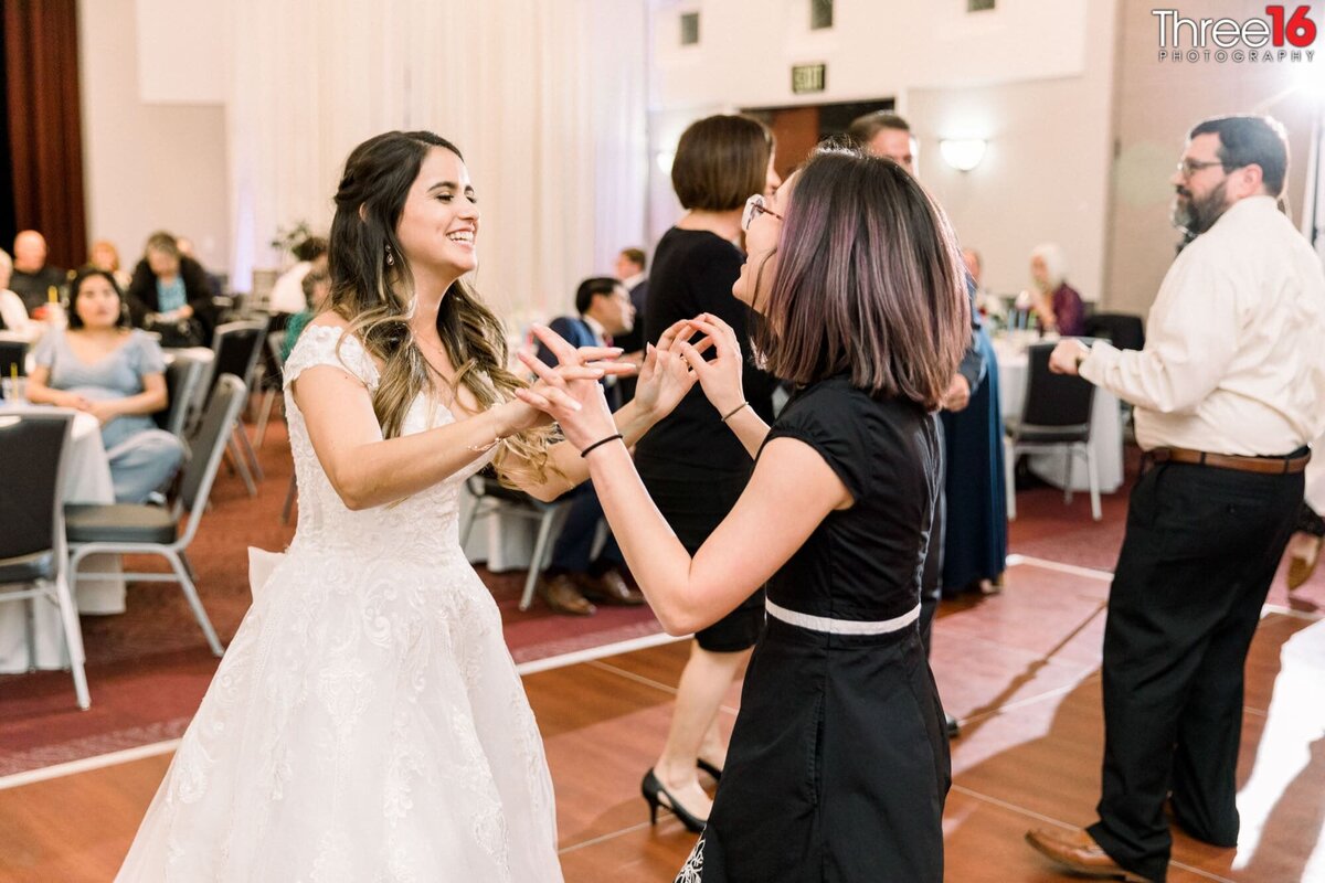 Bride dances with a wedding guest