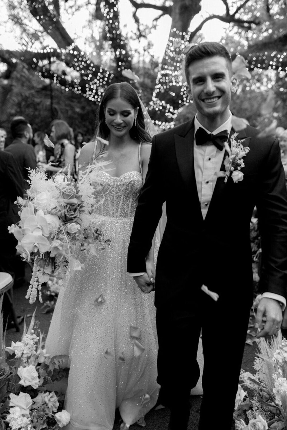 Bride and groom holding hands and walking down aisle, taken by one of the best wedding photographers in orlando florida, Marissa Nicole
