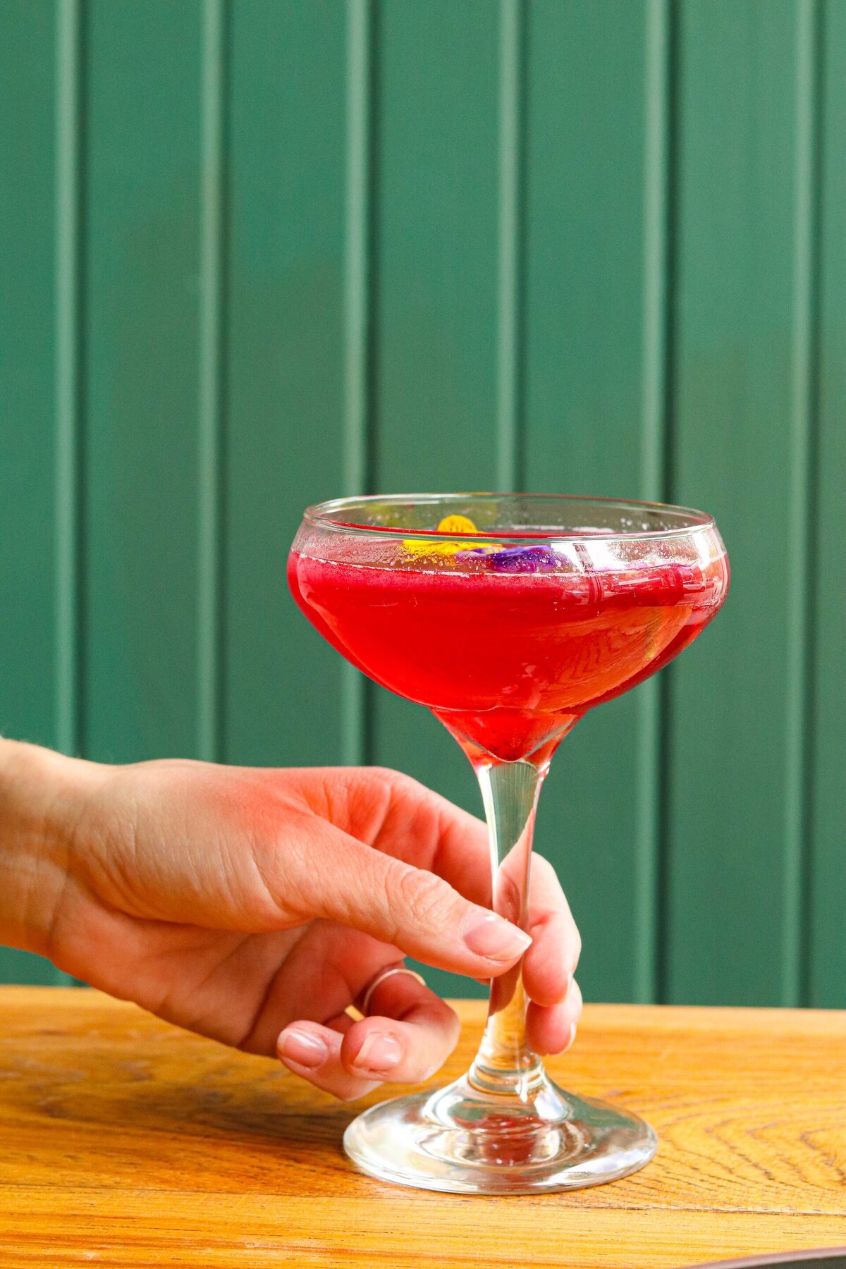 a red cocktail drink in a glass