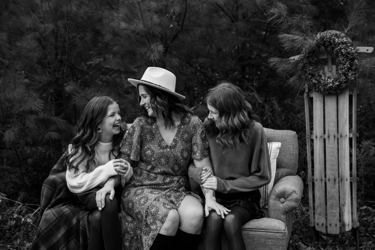 Mom sitting on chair with two daughters | Family Photography Session